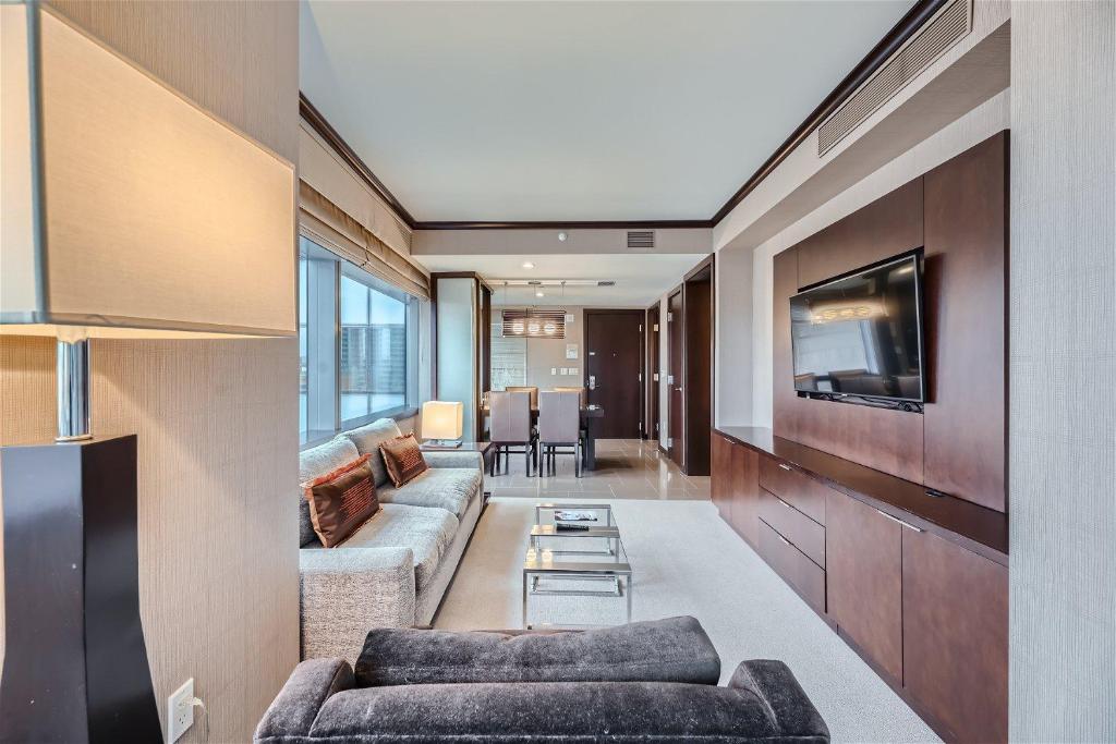 a living room with a couch and a tv at Corner Suite at Vdara Hotel and Spa in Las Vegas