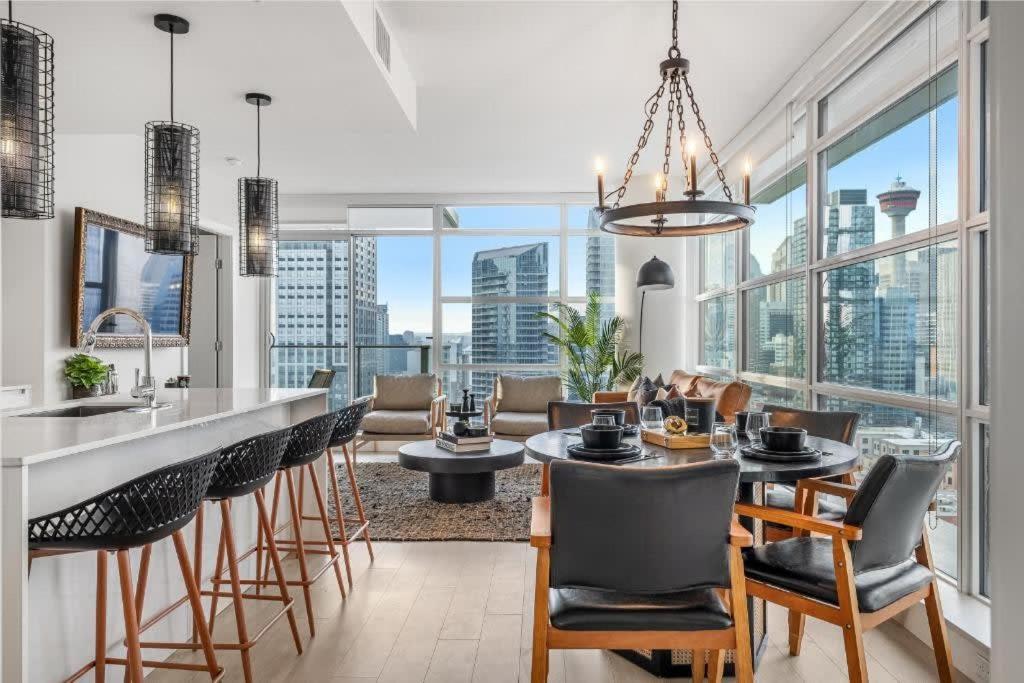 a kitchen and dining room with a view of the city at Manhattan in Calgary