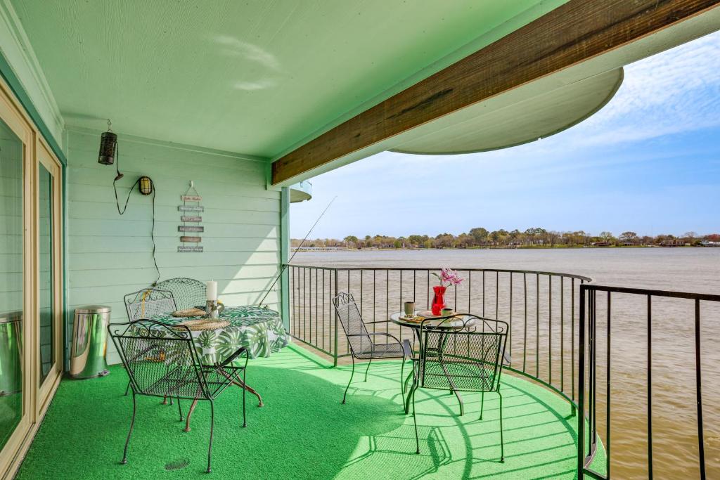 a porch with chairs and tables and a view of the water at Resort-Style Lake Conroe Retreat with Balcony and View in Willis