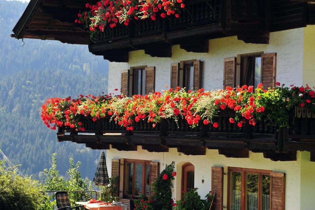 a building with flower boxes on the side of it at Gugghof in Hopfgarten im Brixental