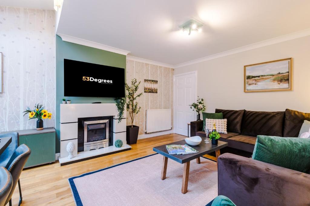 a living room with a couch and a fireplace at NEW! Incredible Home In Northwich By 53 Degrees Property, Perfect For Groups, FREE Parking! in Northwich