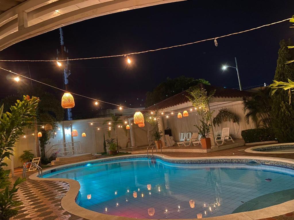 a swimming pool in a backyard at night at Valle Suites Boutique in Valledupar