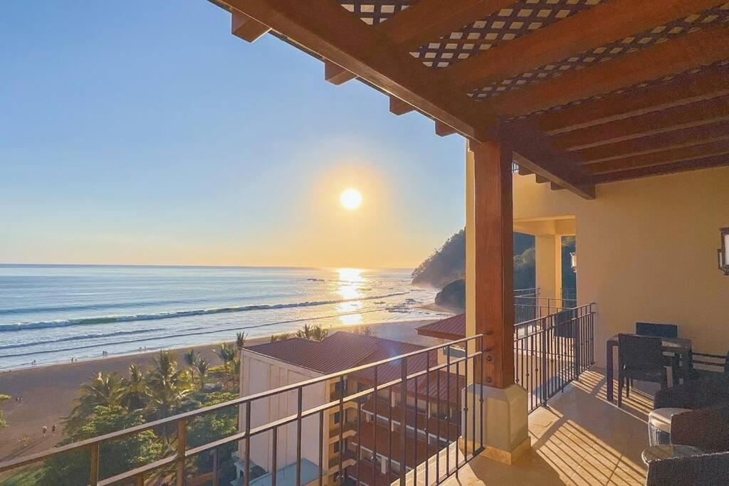 a view of the beach from the balcony of a house at Seaview Oasis 1-BR Suite in Croc's casino resort in Jacó