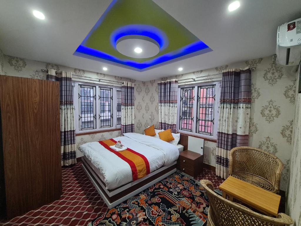 a bedroom with a bed and a blue ceiling at Paru Home 1bhk in Kathmandu