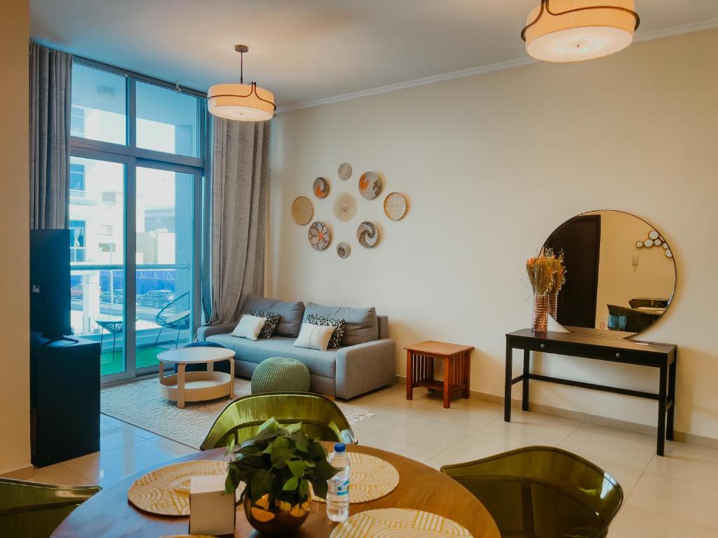 a living room with a couch and a table at Cozy 1 Bedroom in the heart of Dubai Marina in Dubai