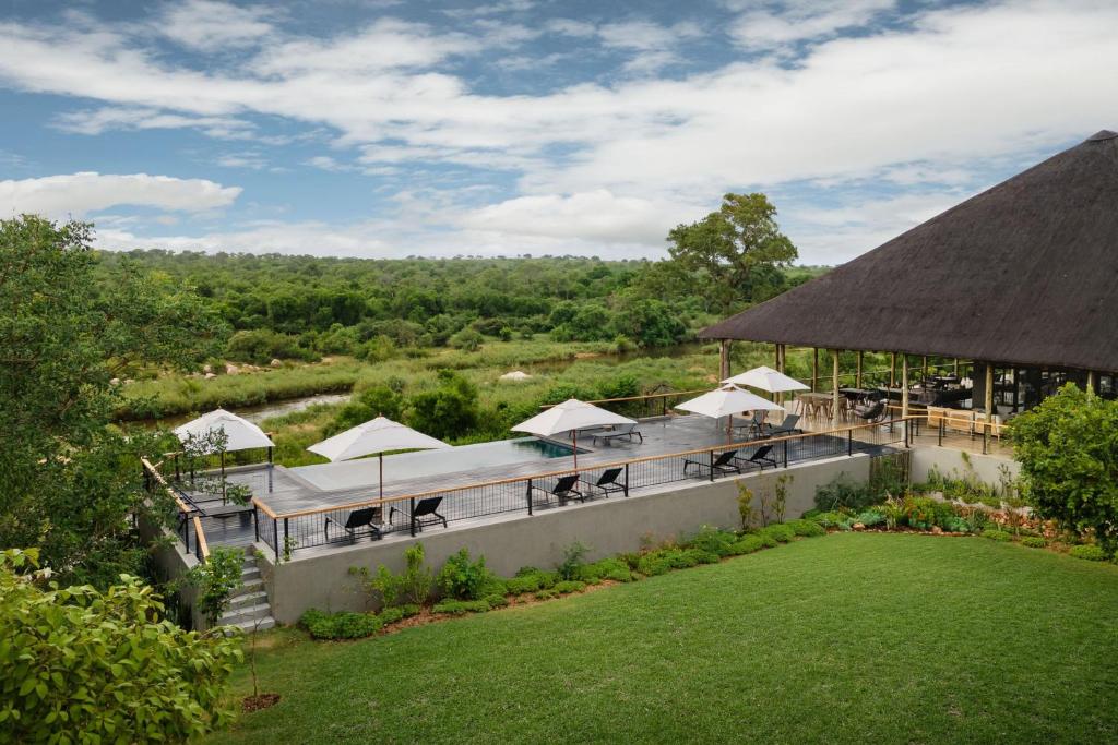 an aerial view of a resort with tables and umbrellas at Leopard Sands Kruger Park in Skukuza