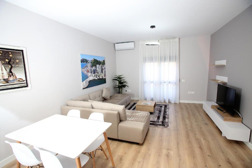 a living room with a couch and a table at The Met Apartments in Durrës
