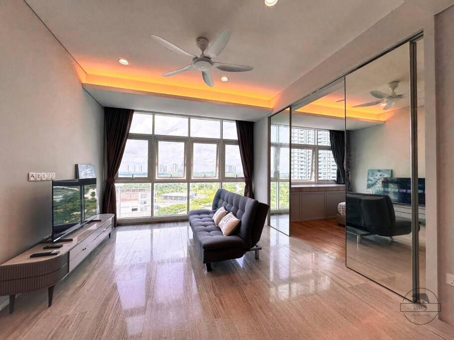 - un salon avec un canapé et un ventilateur de plafond dans l'établissement Pinetree Marina Resort by WP HOMESTAY, à Johor Bahru