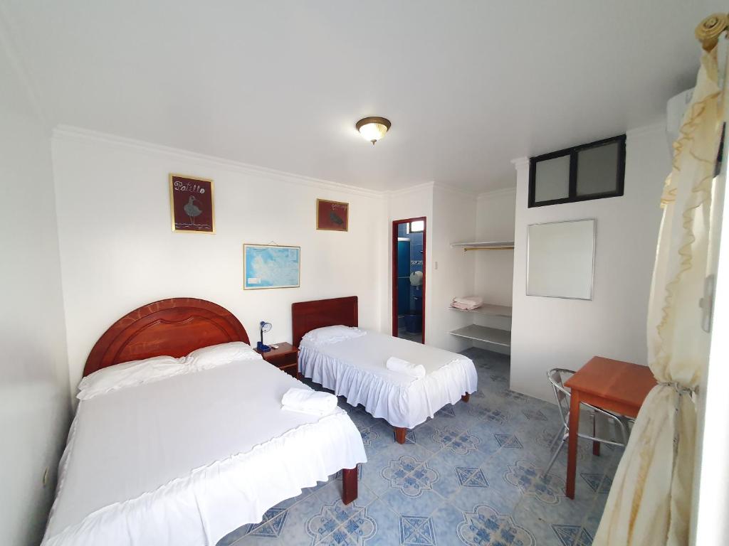Postel nebo postele na pokoji v ubytování Hostal Insular