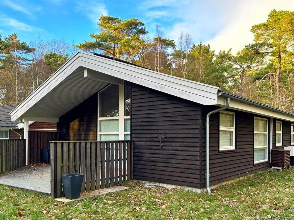 une maison noire avec un garage dans l'établissement Holiday home Hasle CIX, à Hasle