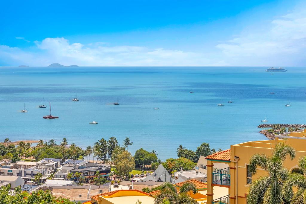 a view of the ocean from a city at Whitsunday Reflections in Airlie Beach