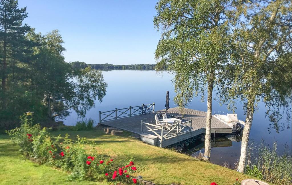 a dock on a lake with a bench on it at Stunning Home In Värnamo With Sauna in Värnamo