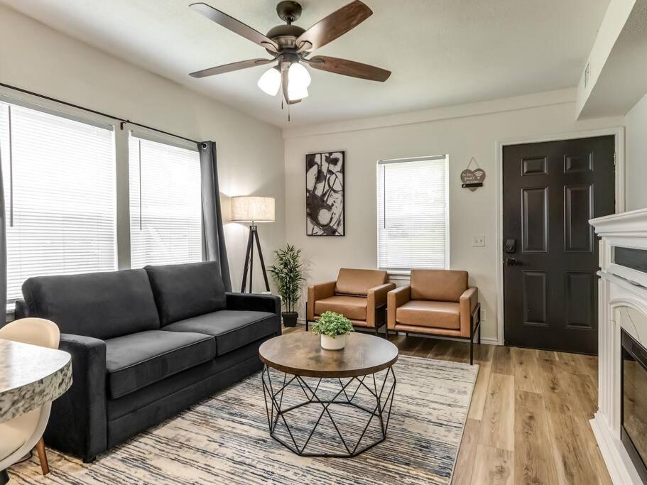 a living room with a couch and a ceiling fan at Stylish & Serene Modern Retreat in Bartlesville