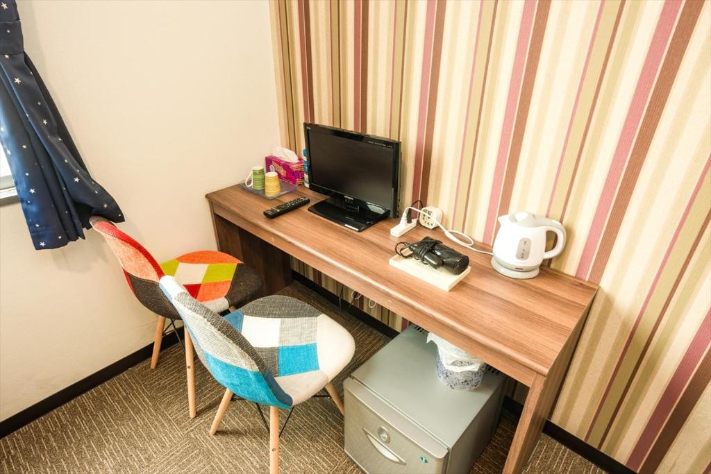 TV a/nebo společenská místnost v ubytování Hotel Ina