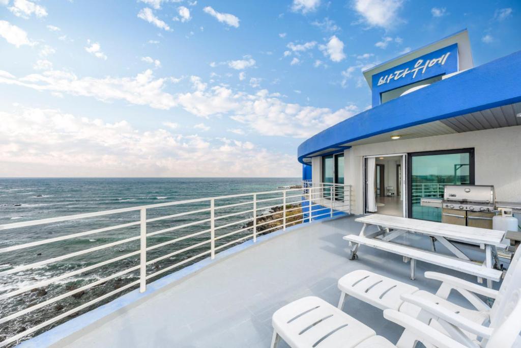 - Balcón de crucero con sillas y vistas al océano en On The Sea Pension en Jeju
