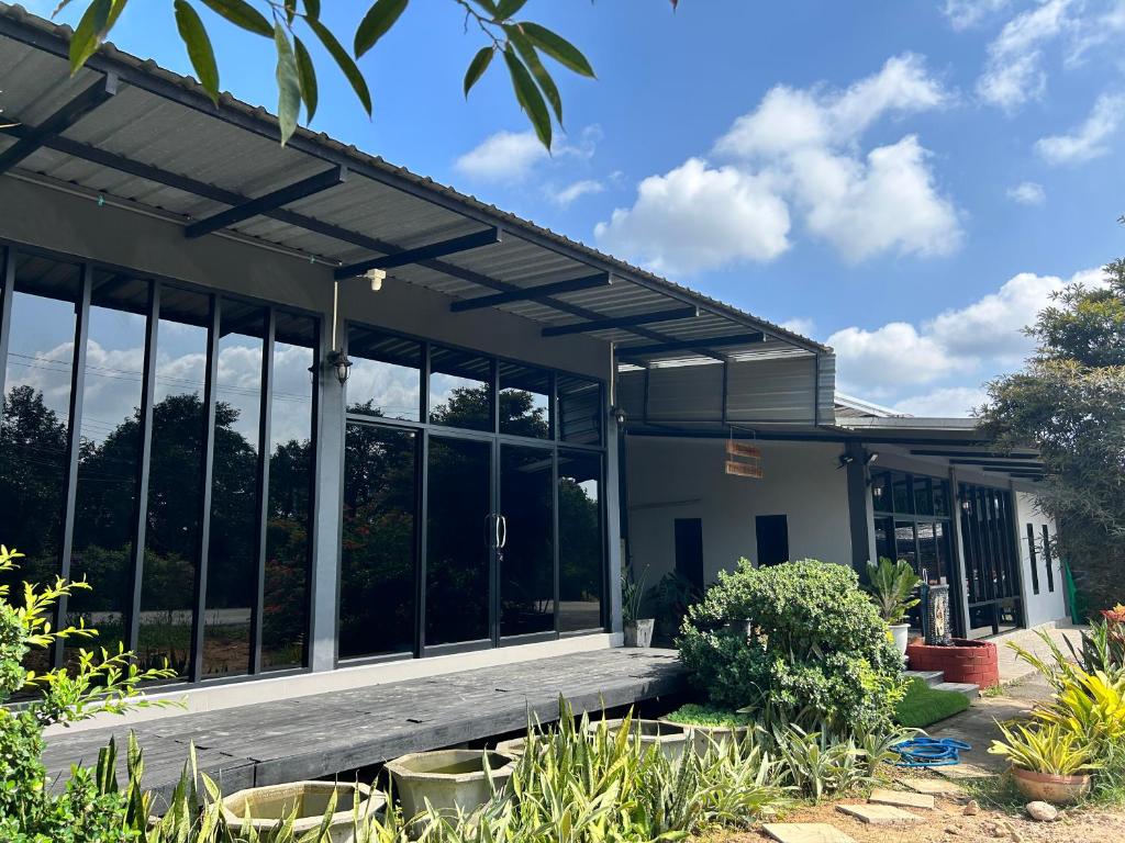 a building with large windows in a garden at WildernessMountain View in Ban Thung Ta In