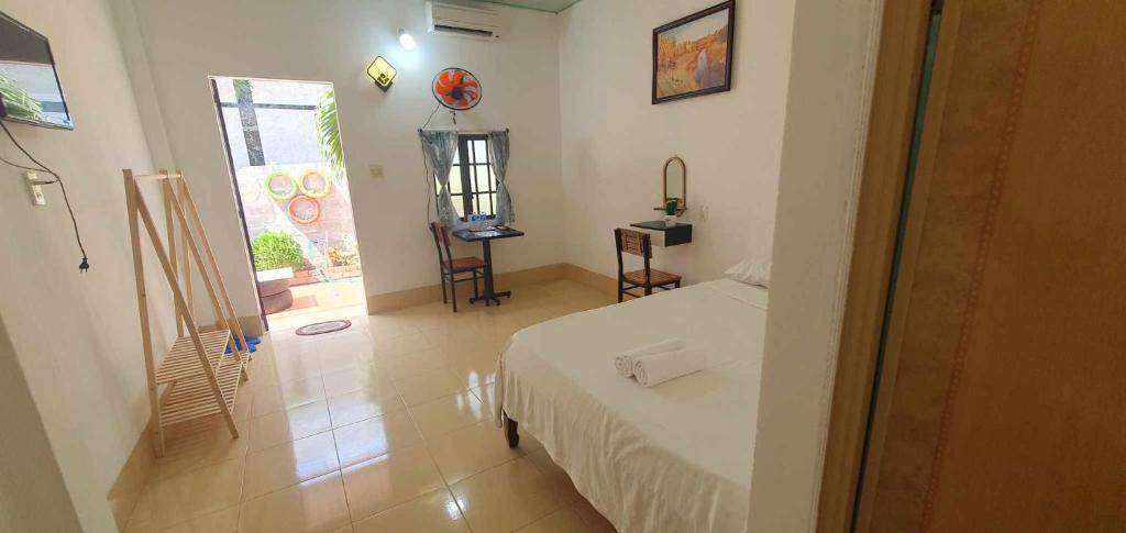 a small bedroom with a bed and a window at MUI NE BEACH in Ấp Thiện Phước