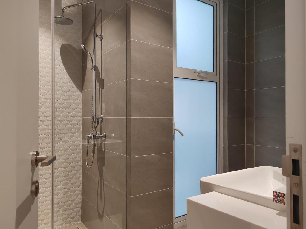 a shower with a glass door in a bathroom at Quill Residence KLCC By Ezhome in Kuala Lumpur