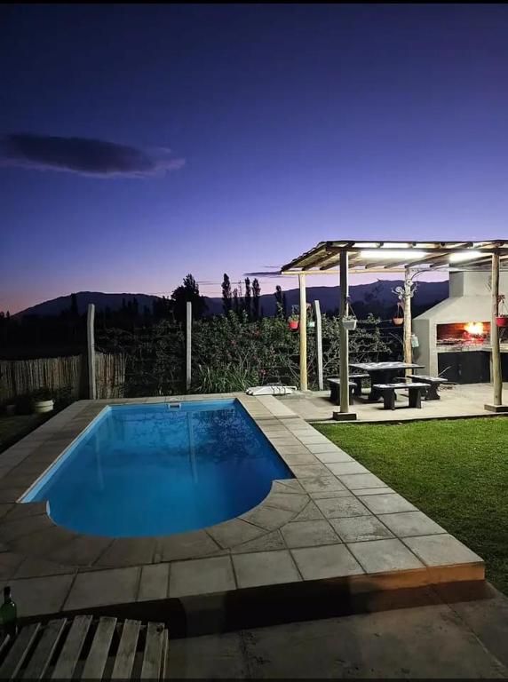 a swimming pool in the middle of a yard at ANJANA Cabaña con pileta y vista a la pre cordillera in Ullún