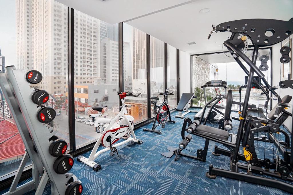 A compact, window-lined gym with cardio and weight-training equipment.