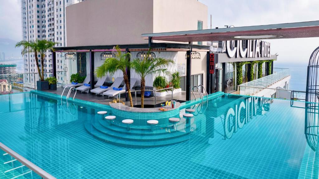 The rooftop pool is shown in daylight with a circular swim-up feature and city buildings behind.