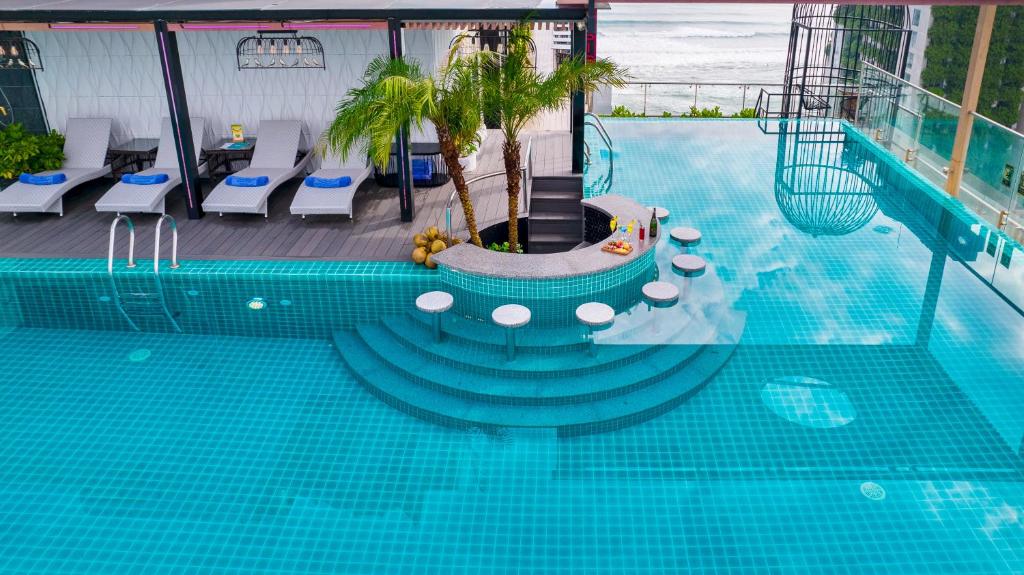 An overhead view reveals the rooftop pool’s circular seating feature and shallow steps.