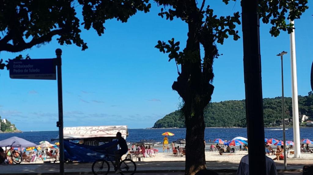a person riding a bike at the beach at Eduardo Gimenes Palazzi in São Vicente