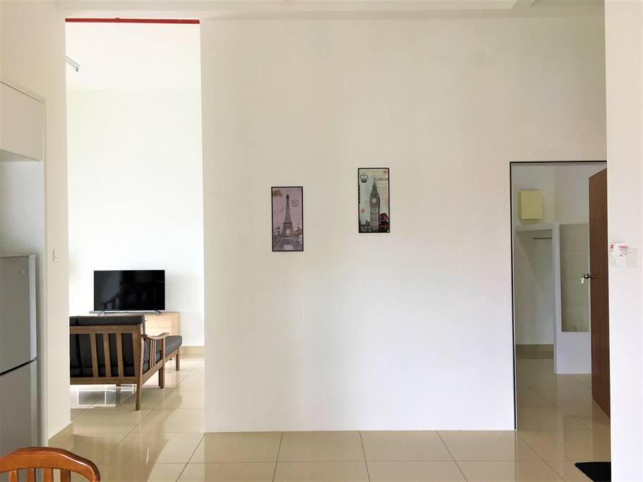 a room with a white wall with three pictures on it at Cozy Homestay at Menara Hartamas 1-4pax in Johor Bahru