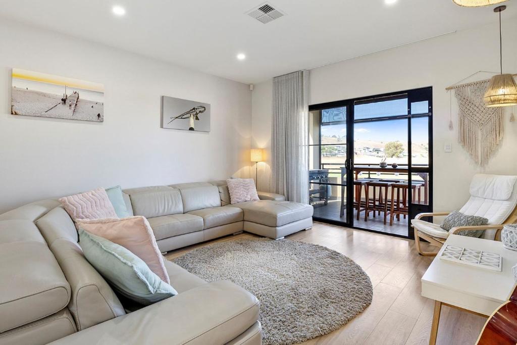 a living room with a couch and a table at 3 61 St Andrews Boulevard in Normanville