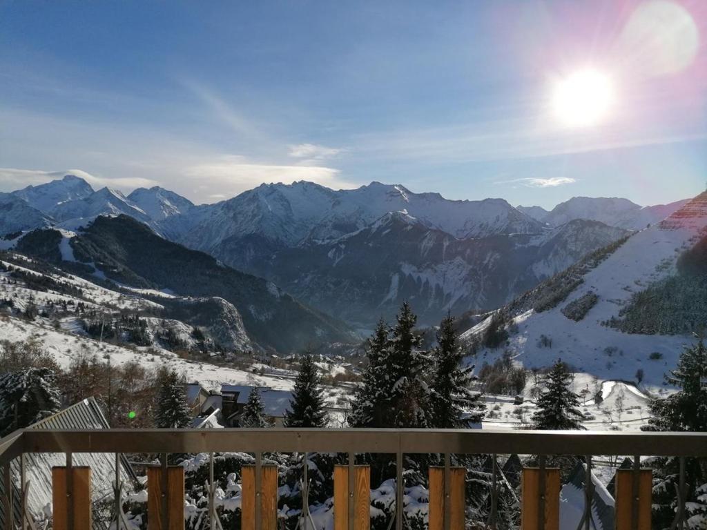 - une vue sur une chaîne de montagnes enneigée avec le soleil au ciel dans l'établissement Appartement 2 pièces, 6 pers, Alpe d'Huez, animaux bienvenus - FR-1-405-355, à Huez