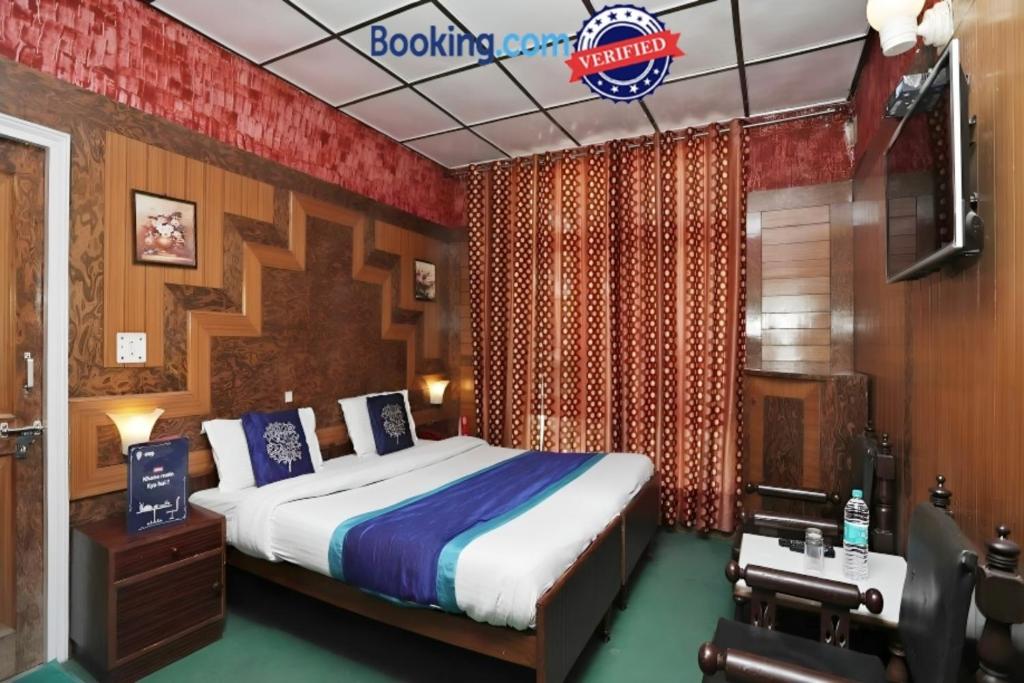 a bedroom with a bed and a camera in a room at Goroomgo Ankur Lake View Mall Road Nainital - Prime Location with Luxury Room in Nainital