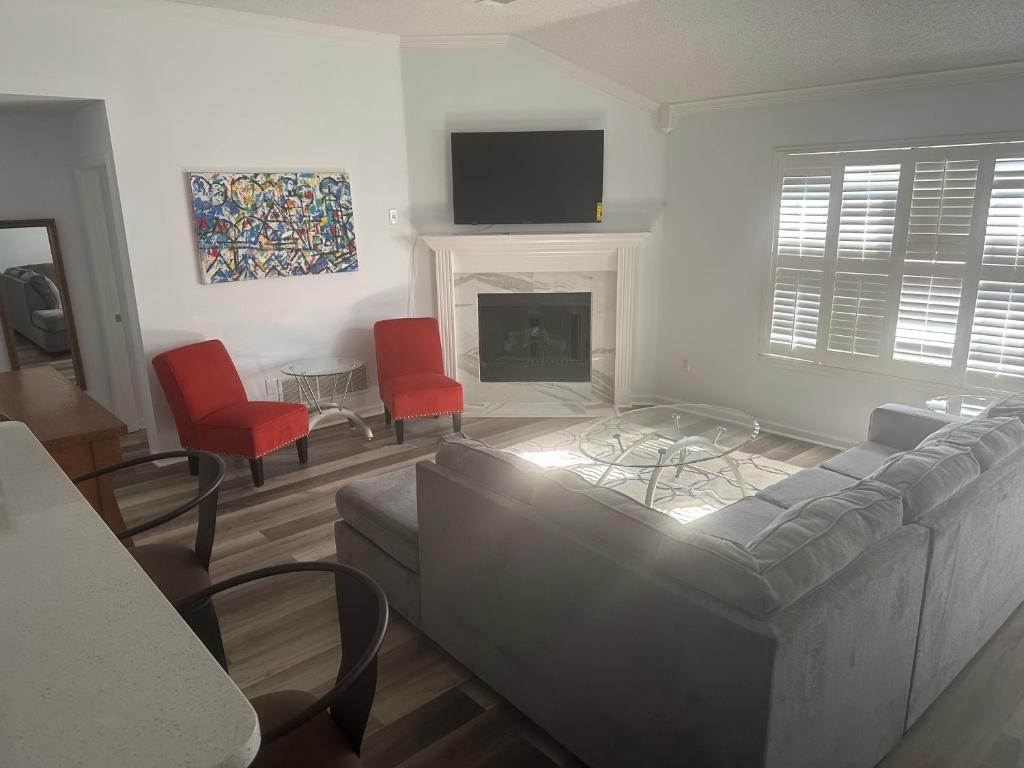 a living room with a couch and a fireplace at Encie’s Estate in Memphis