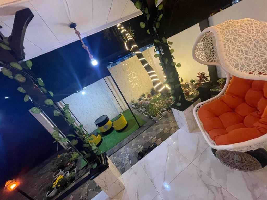 an overhead view of a living room with an orange chair at Villa Omar in Cikujang