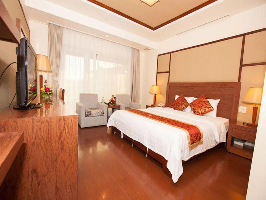 a bedroom with a large bed and a television at Sao Mai Hotel - 23 Tôn Đức Thắng - by Bay Luxury in Hanoi