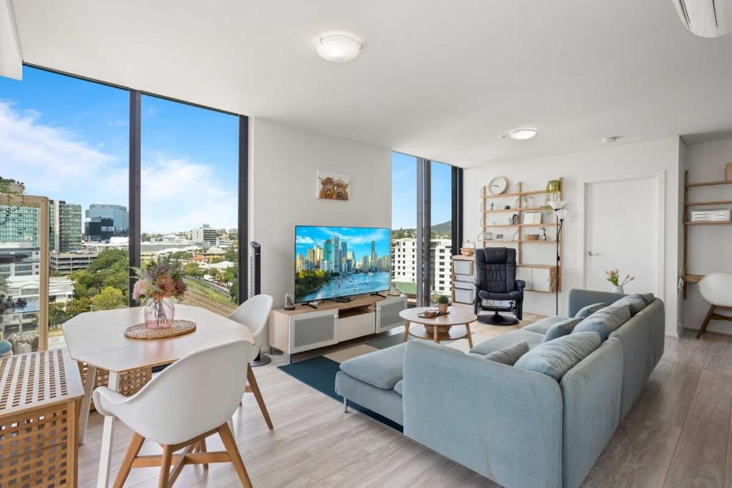a living room with a couch and a table at Spaciously Bright 1-Bed Apartment in Brisbane