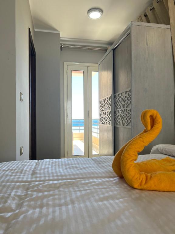 a bed with an orange object on top of it at KUBA LuXuS - VillA in Sahl hashesh-hurghada in Hurghada