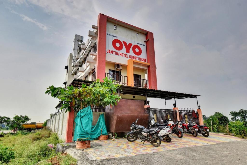 a group of motorcycles parked in front of a building at OYO Flagship Jamtha Hotel Guest House in Nagpur