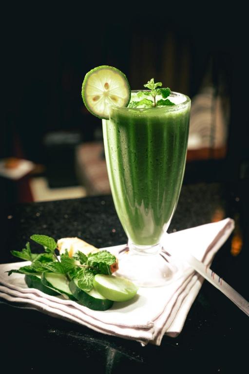 a green drink in a glass on a table at After 40 Hotel in Nairobi