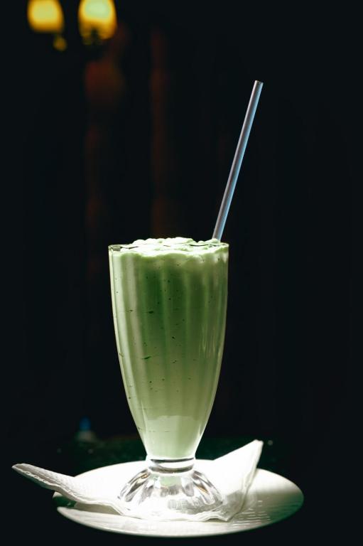 a green drink in a glass on a plate at After 40 Hotel in Nairobi