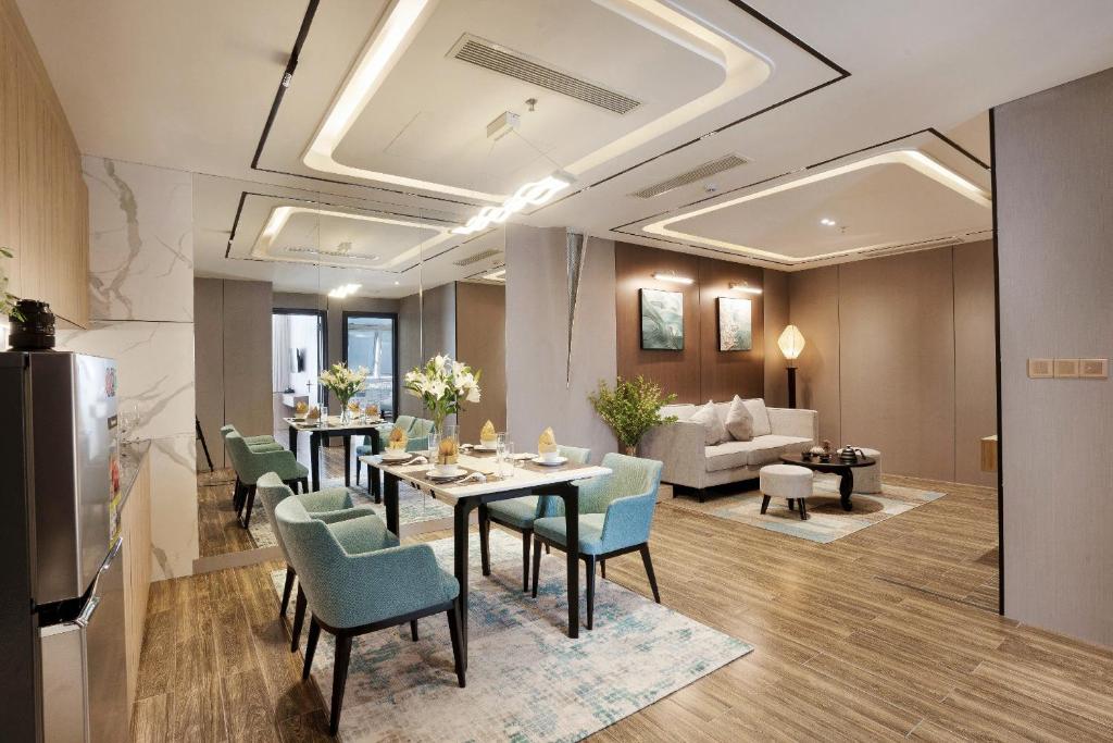 An open-plan suite with a dining table, kitchen appliances and separate lounge seating.