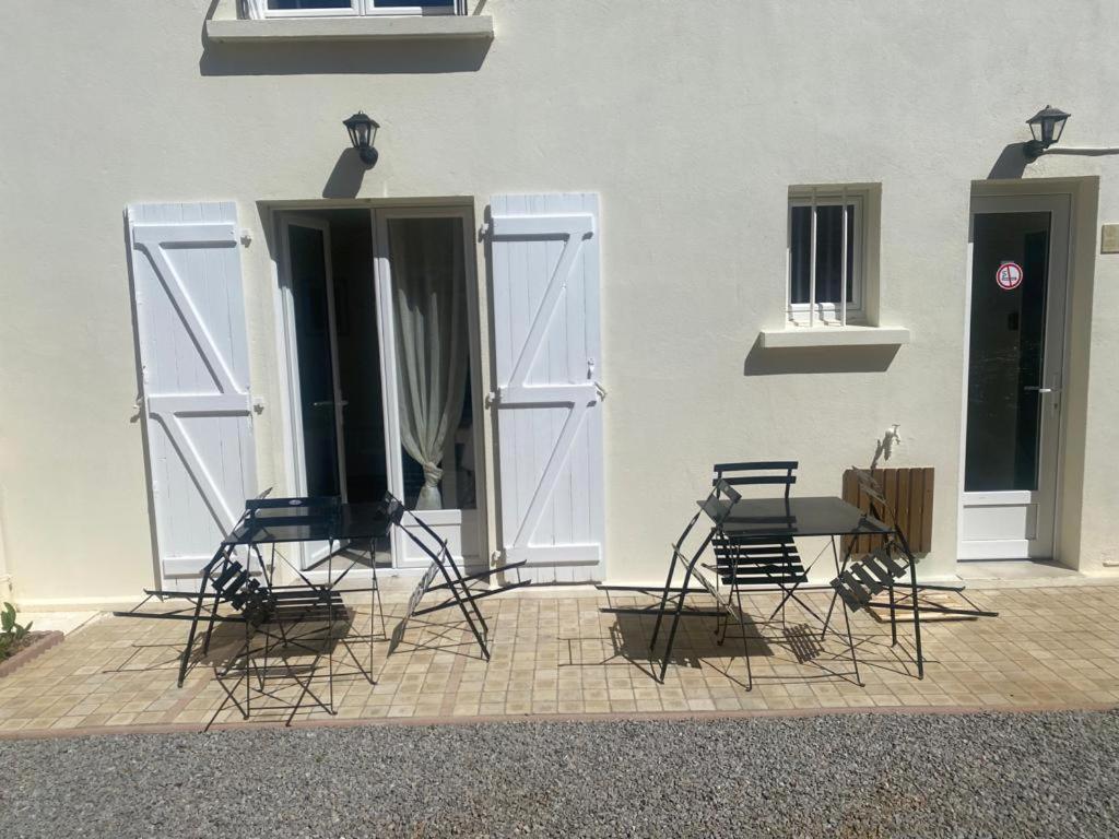 four chairs and a table in front of a building at Home concept Gace 1 - Superb apartment in Gacé in Gacé