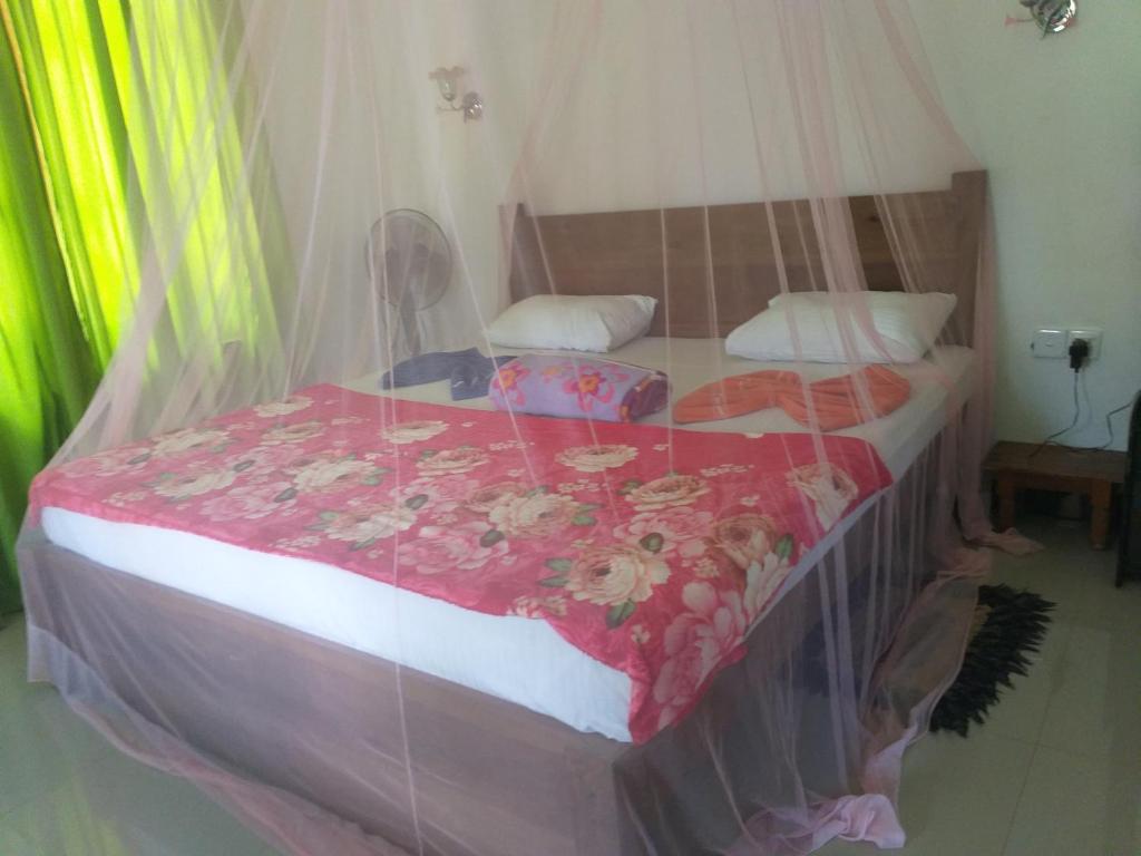 Postel nebo postele na pokoji v ubytování Nine Arch Araliya Homestay