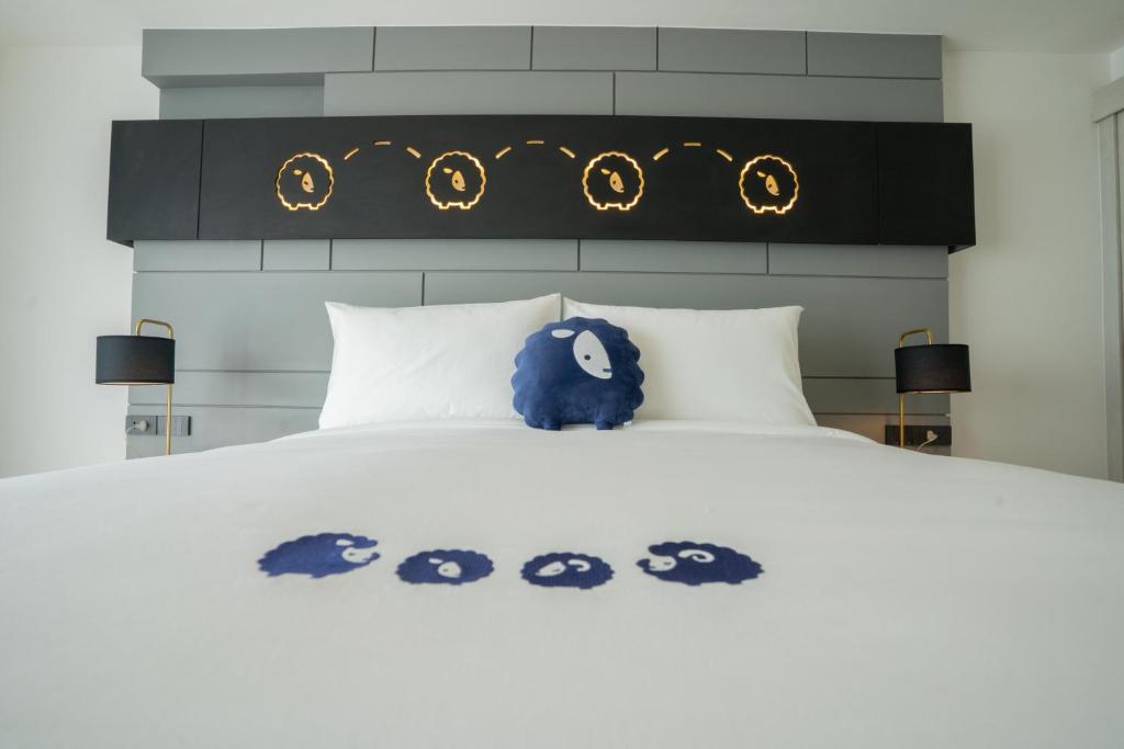 Kokotel Chiang Rai Airport Suites tesisinde bir odada yatak veya yataklar