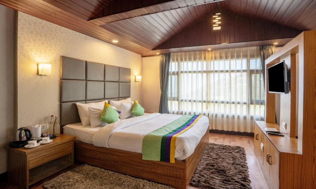 Postel nebo postele na pokoji v ubytování Treebo Eeshan Rodhi Resort, Darjeeling