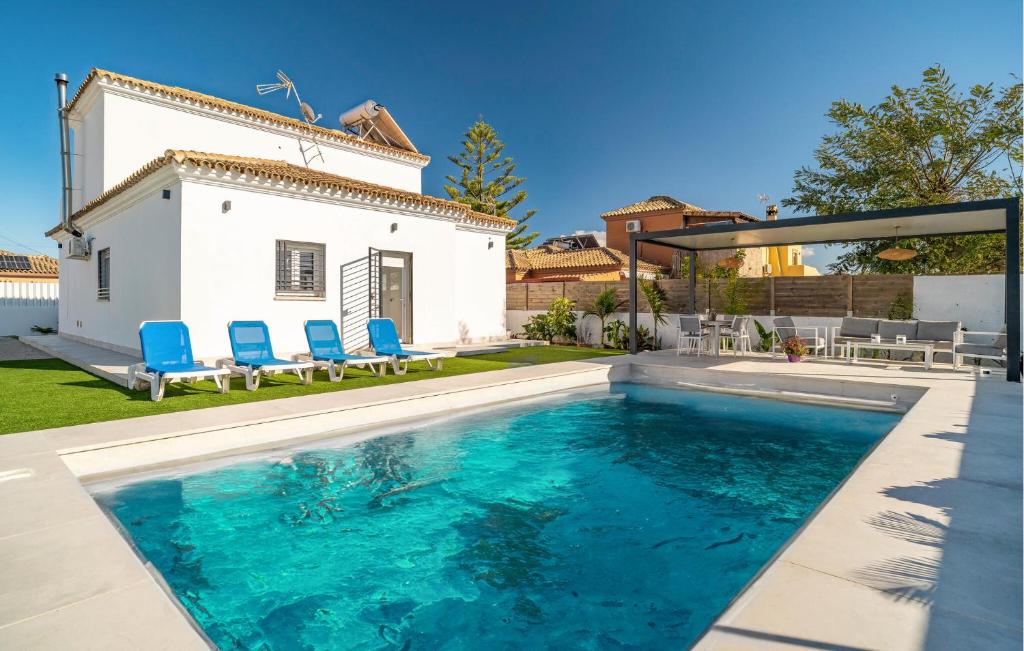 a swimming pool in the backyard of a house at Gorgeous Home In Chiclana De La Fronter in Chiclana de la Frontera
