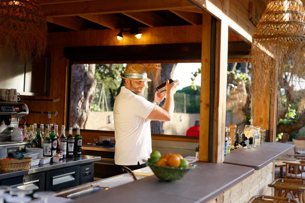 a man taking a picture of a bar at La Ferme D'Augustin in Saint-Tropez