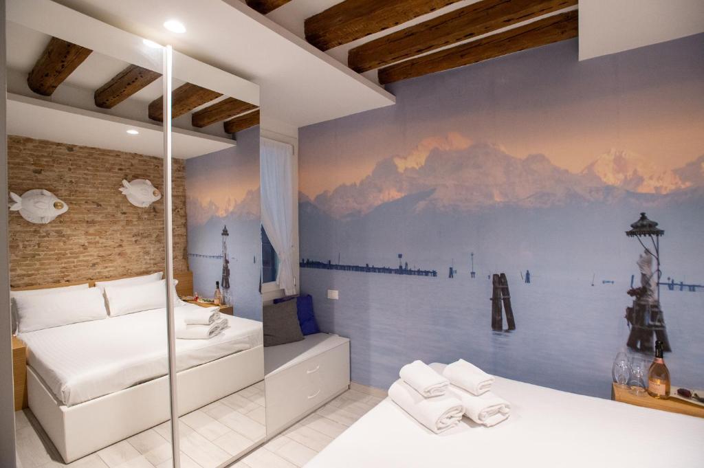 a bedroom with a mountain mural on the wall at Stravedamento MyTravelChioggia in Chioggia