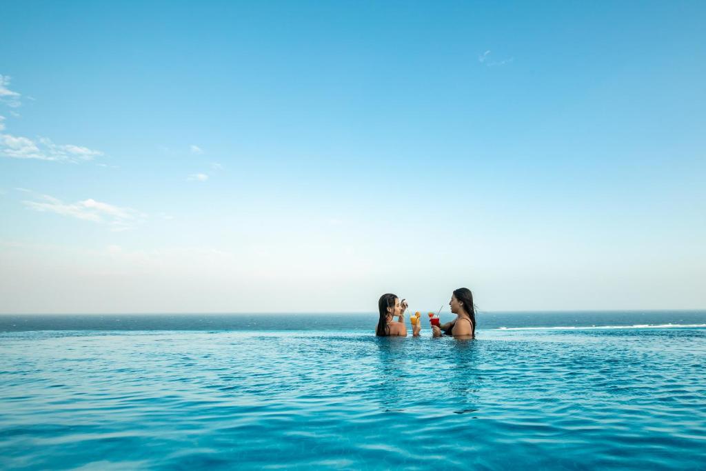 two women and a child in the water at Triton Prestige Seaview and Spa in Maafushi