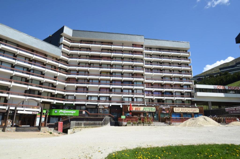 a large apartment building in front of a street at Résidence Chaviere - Studio pour 2 Personnes 034 in Les Menuires