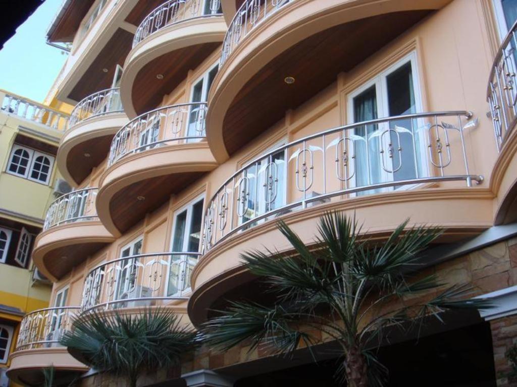 a building with a palm tree in front of it at P.72 Hotel in Pattaya South